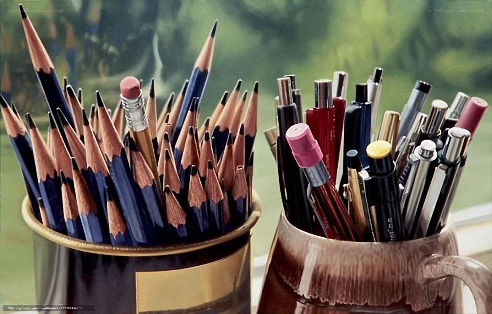 Pencils and pens in cups