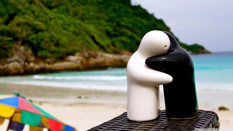 Penguin figurines on a beach