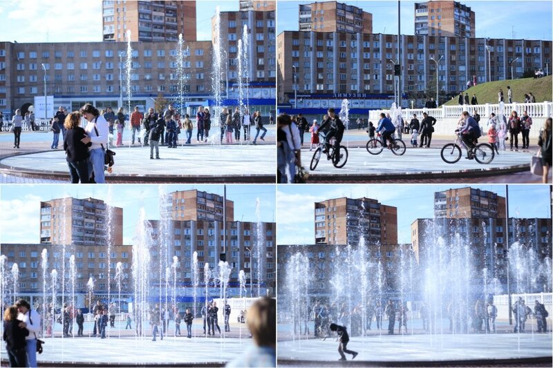 People at a fountain in a city