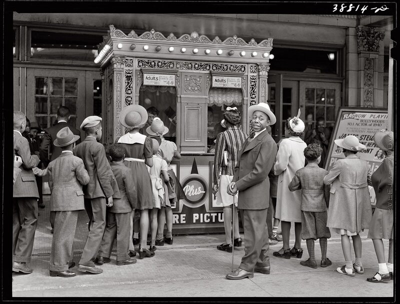 People at a movie theater ticket booth