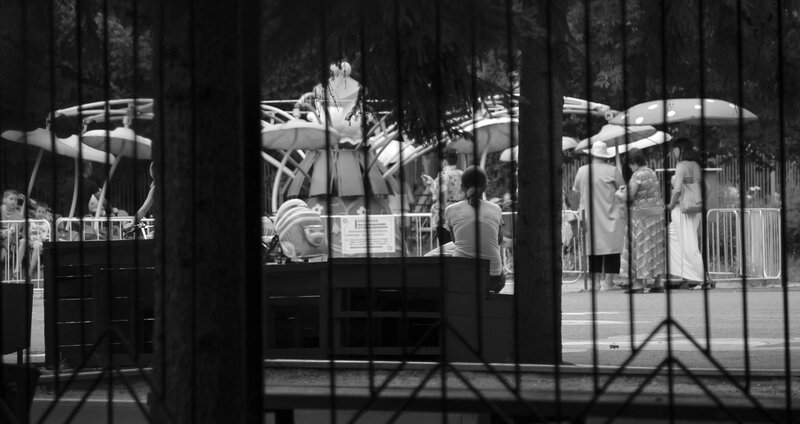 People at a park through fence