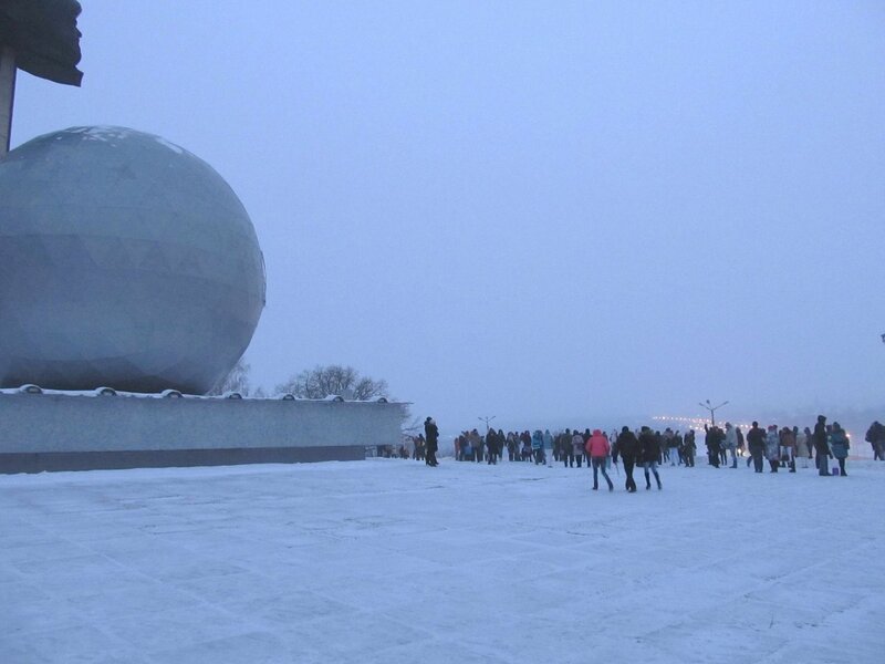 People at a snowy monument site
