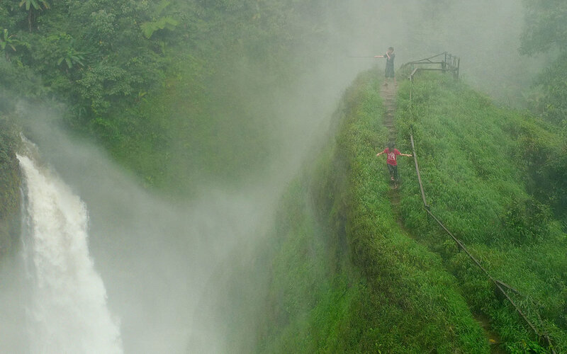 People at a waterfall viewpoint