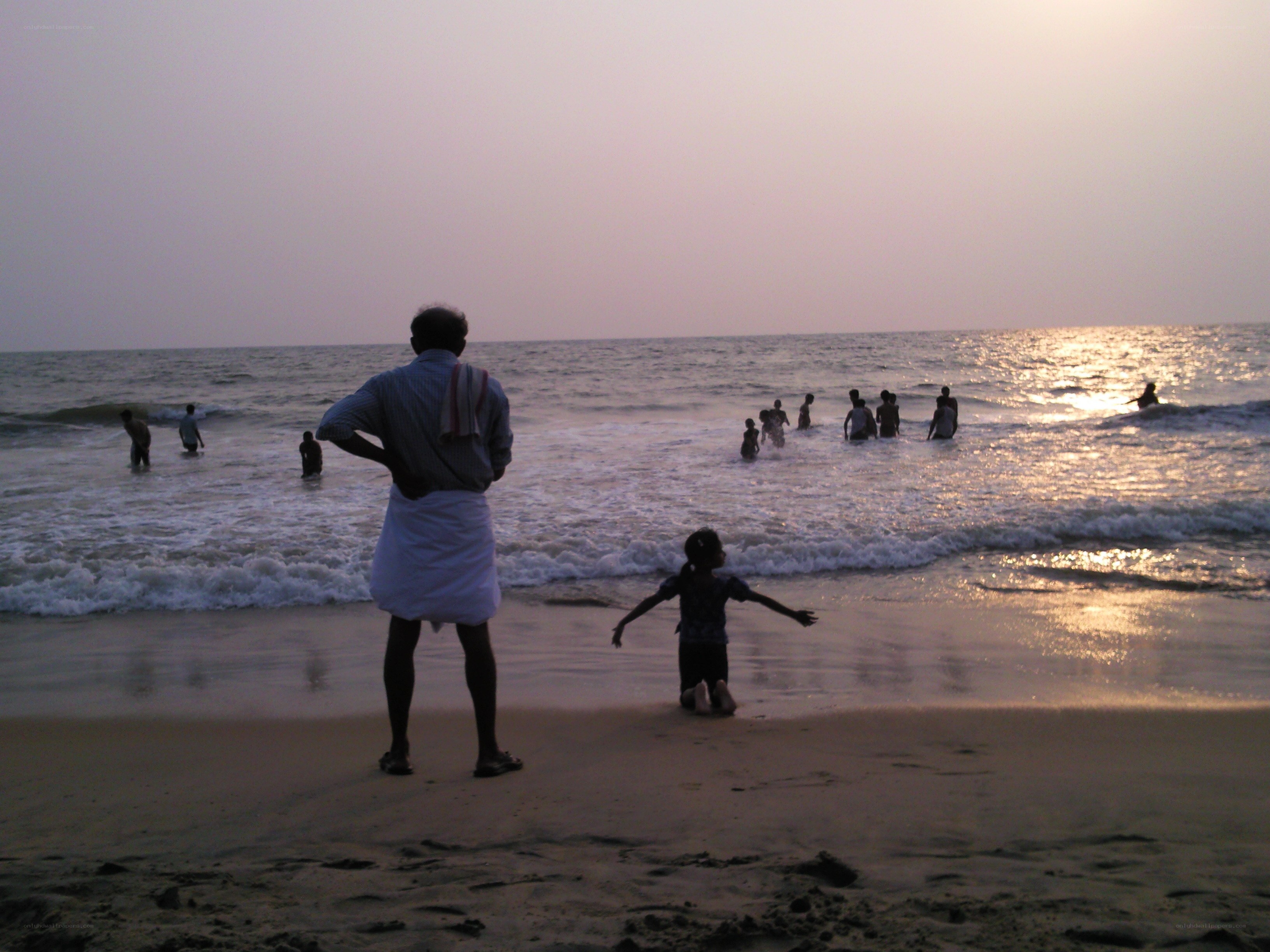 People at the beach at sunset
