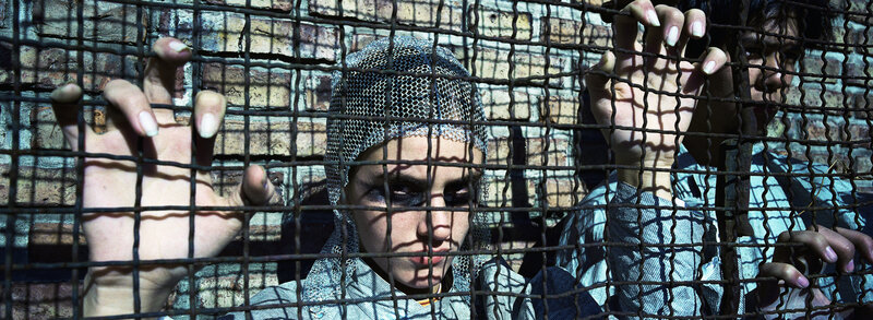 People behind a metal grid