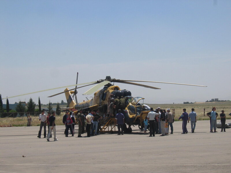 People boarding a military helicopter