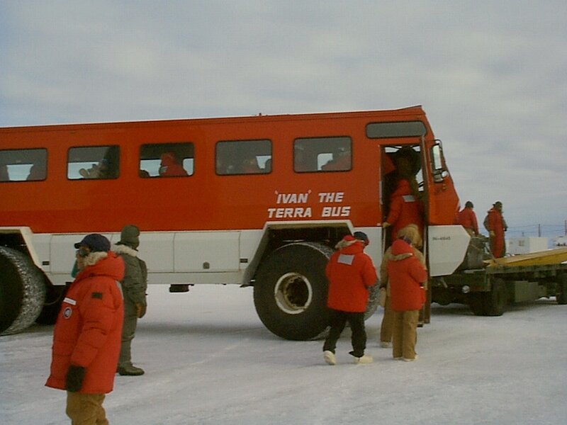People boarding a snow vehicle