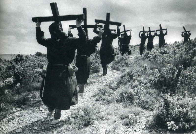 People carrying crosses on a hill