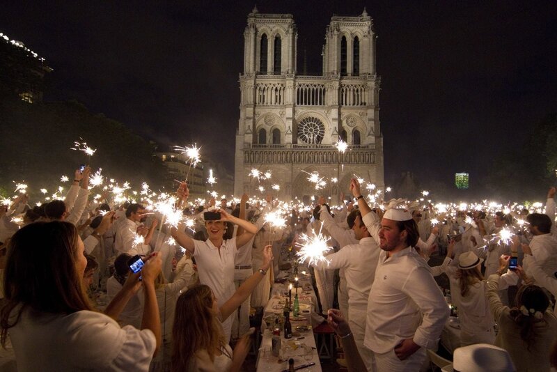 People celebrating with sparklers at night