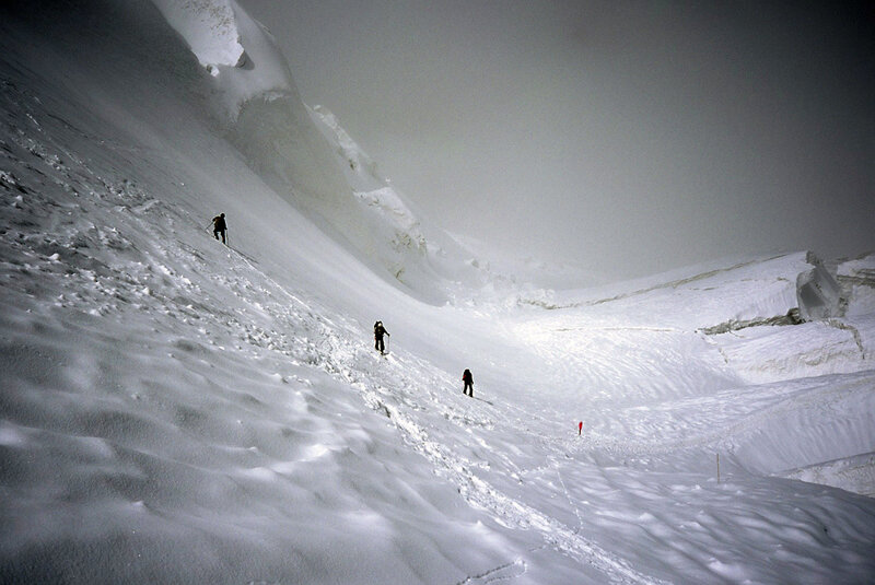 People Climbing Snowy Slope