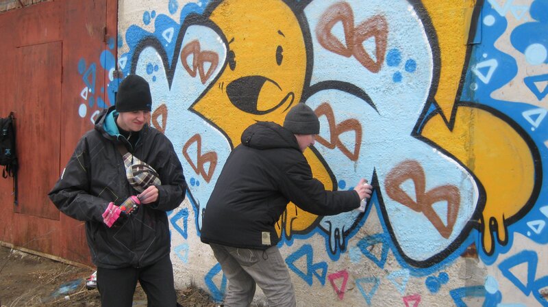 People creating graffiti art