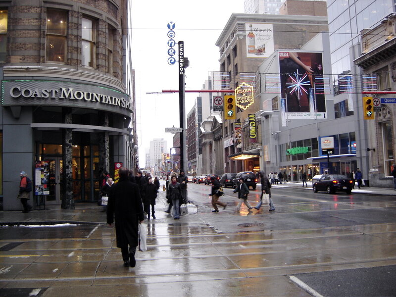 People crossing a wet street in downtown