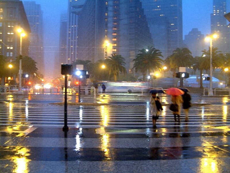 People crossing street in rain
