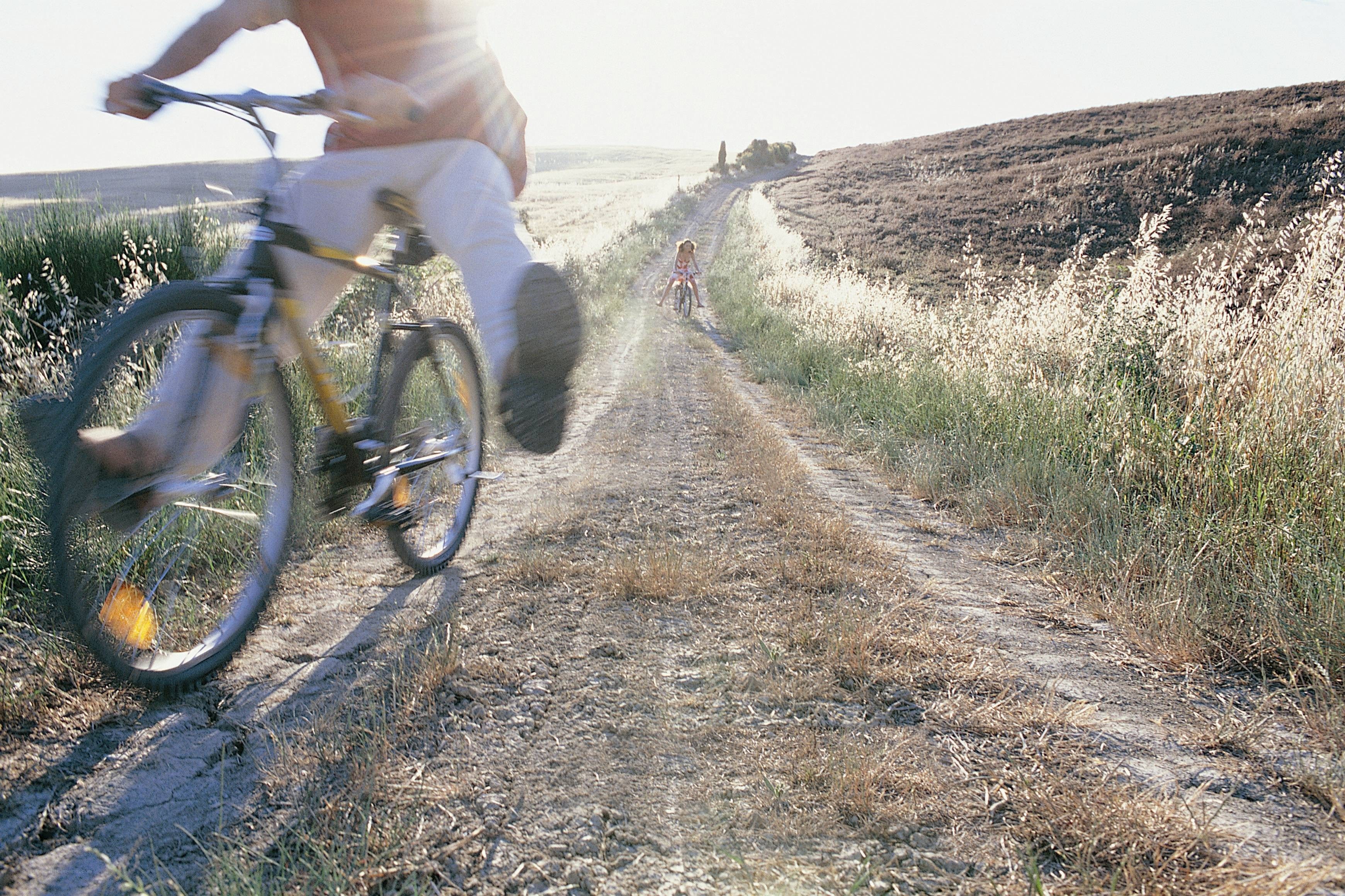 People cycling on a dirt path