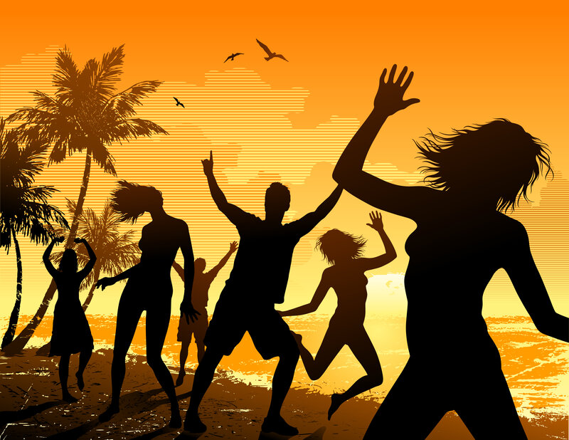 People dancing on a beach at sunset