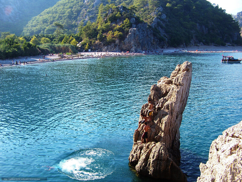 People diving from a rock