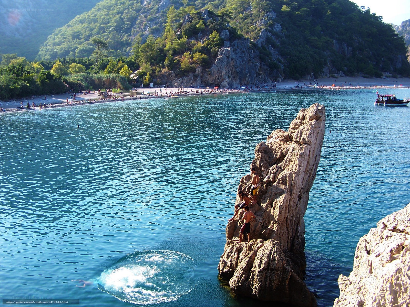 People diving from a rock
