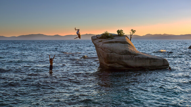 People Diving into Lake
