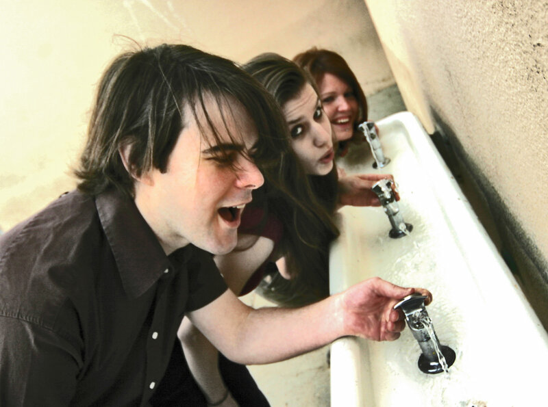 People drinking from sinks