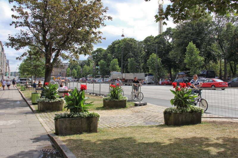 People enjoying a park by the road
