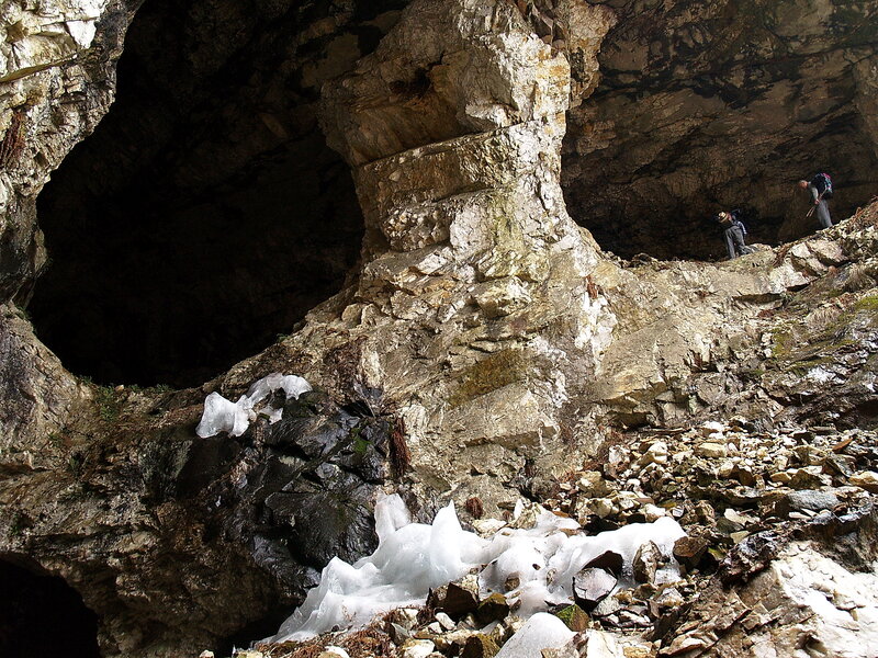 People Exploring Cave — Gray