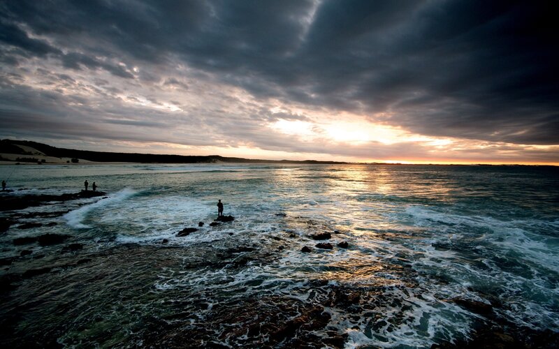 People Fishing on Rocks