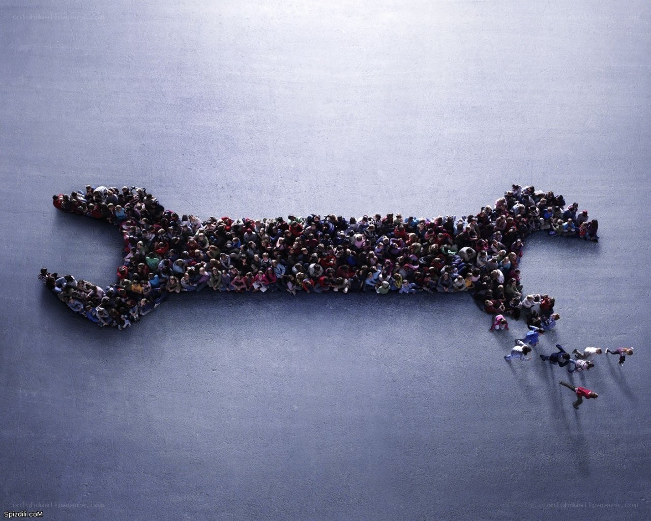 People forming a wrench shape