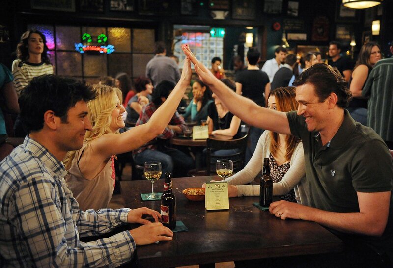 People High-fiving at Bar