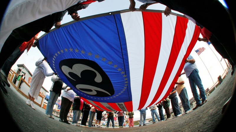 People holding a large flag