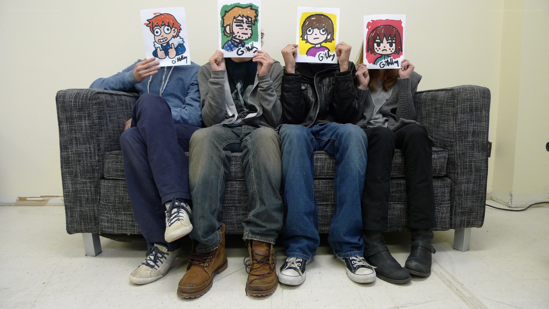 People holding character drawings