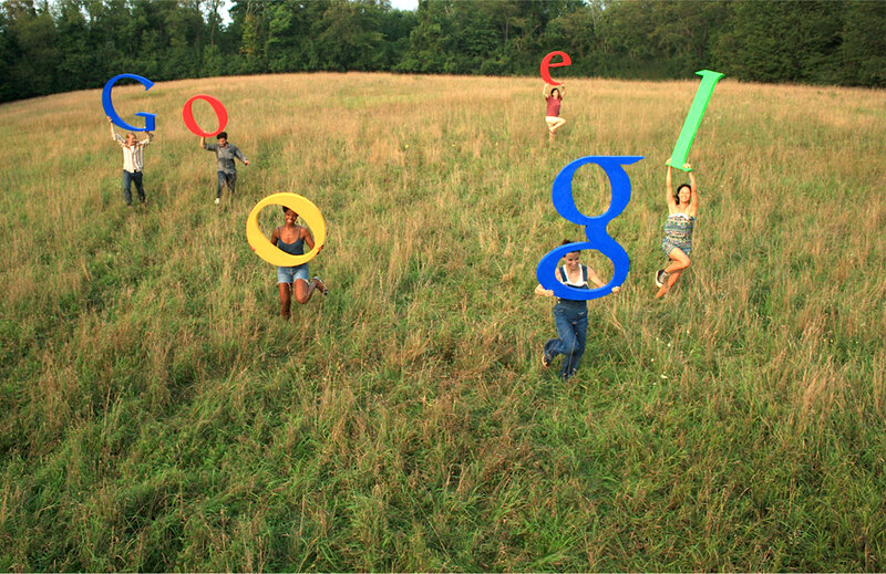 People Holding Letters in Field