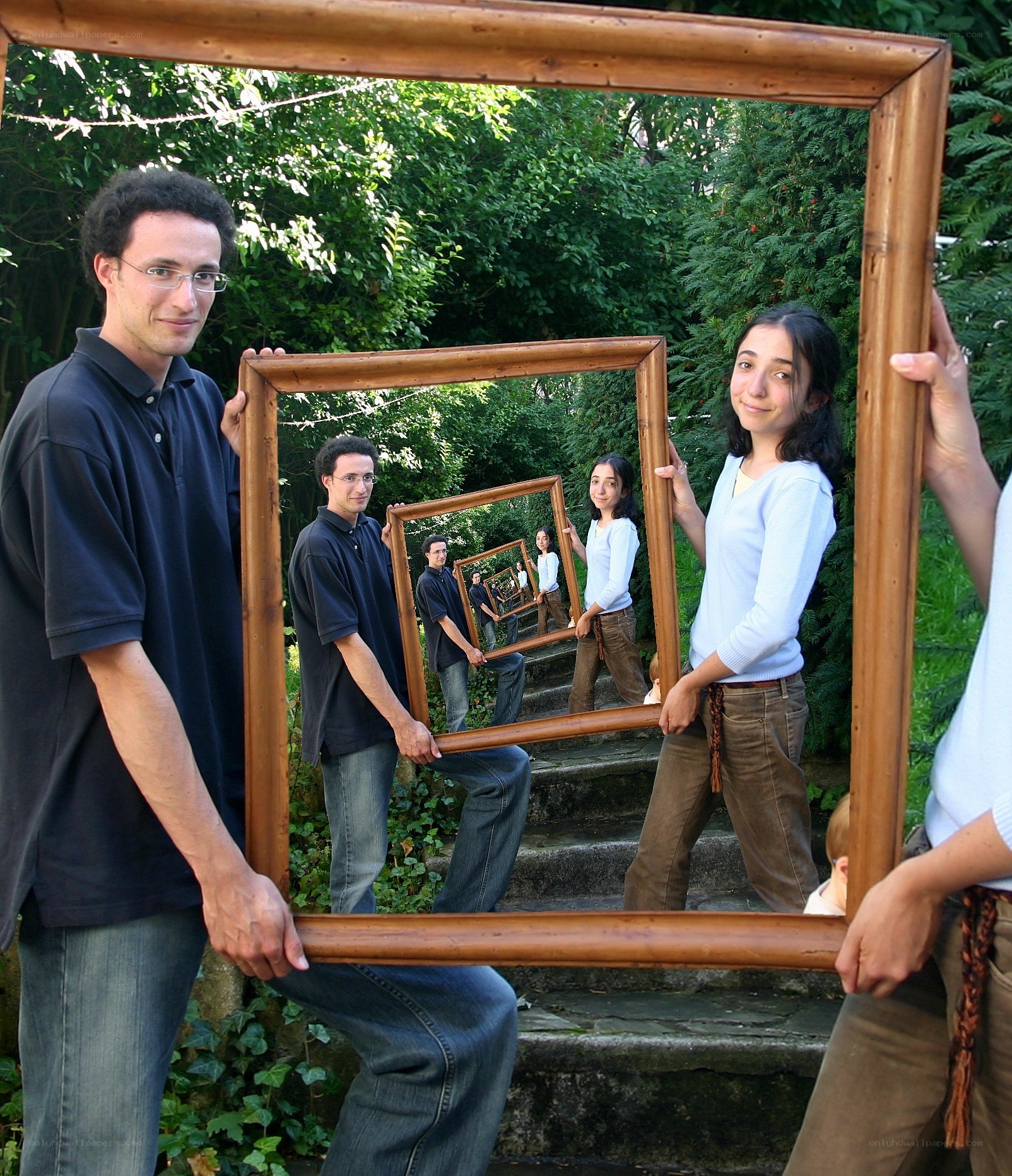 People holding picture frames in a mirror effect