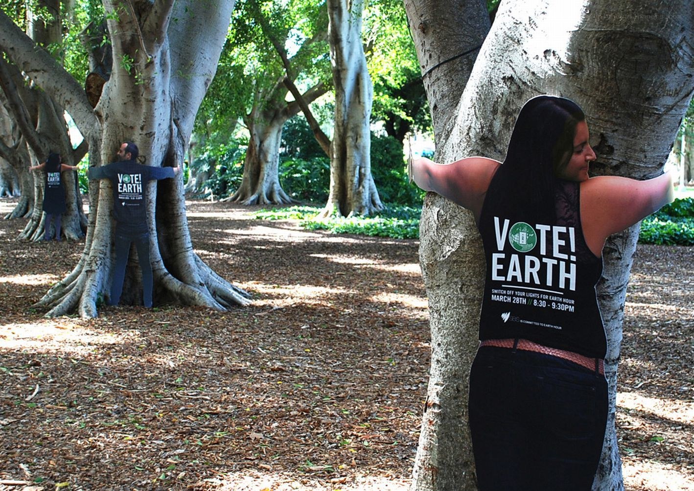 People hugging trees for Earth Hour