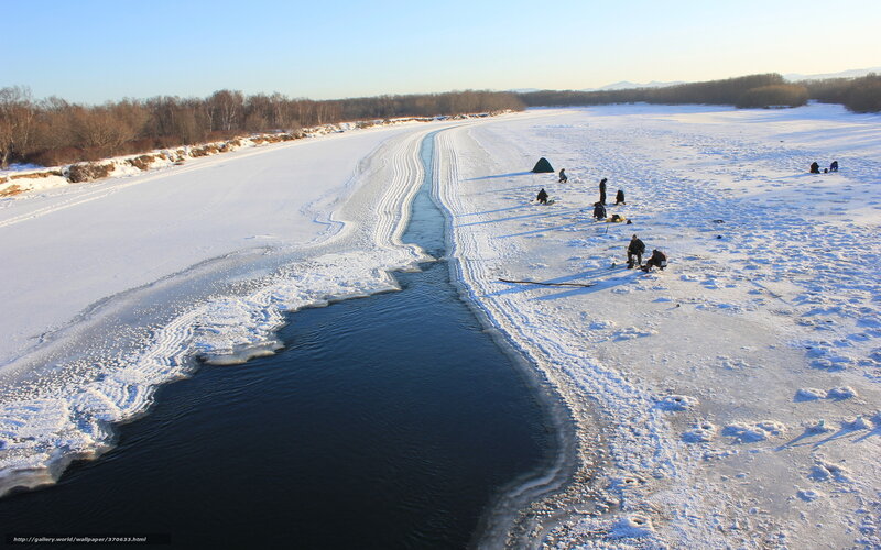 People ice fishing on a frozen river