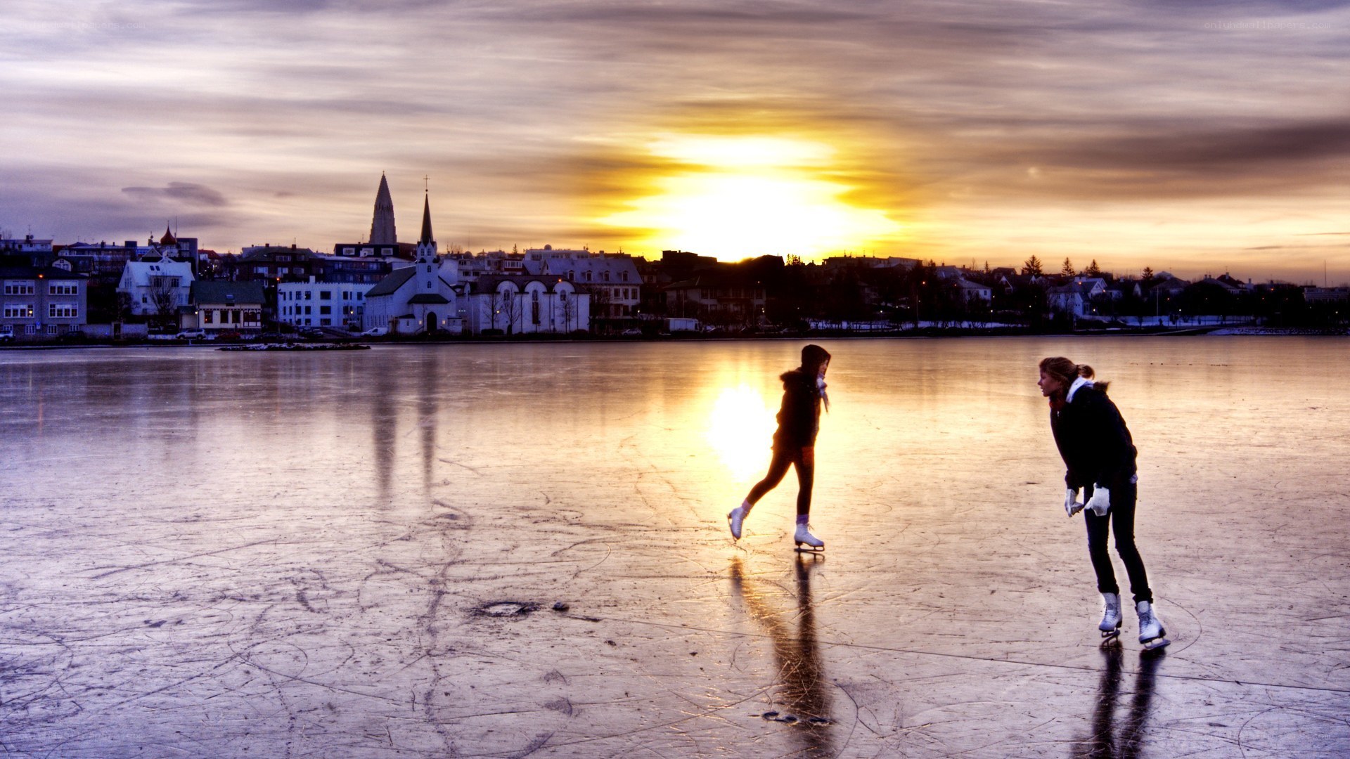 People ice skating at sunset