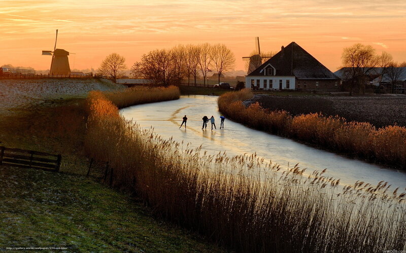 People ice skating on a canal