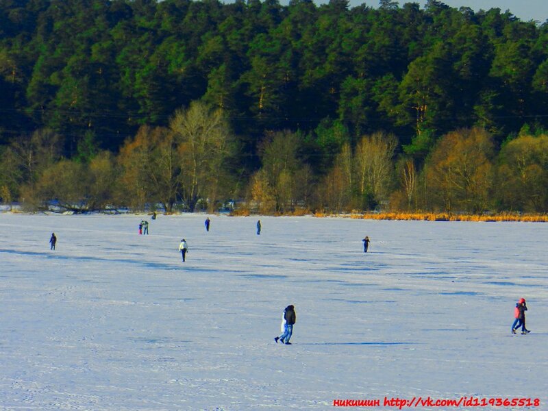 People ice skating on a frozen lake