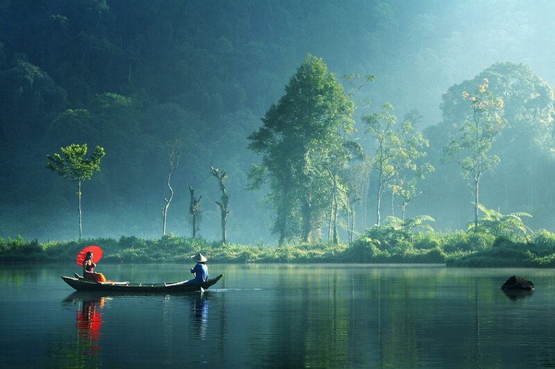 People in a boat on a misty river