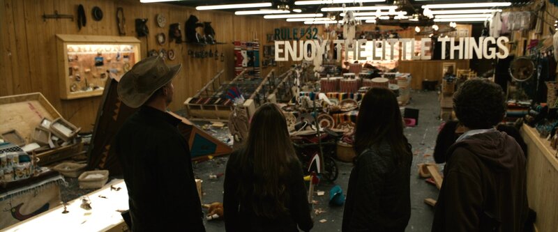 People in a cluttered gift shop