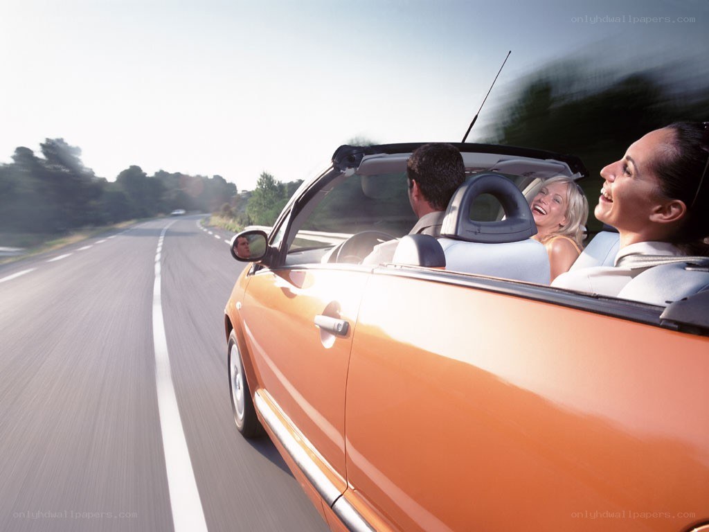 People in a convertible car