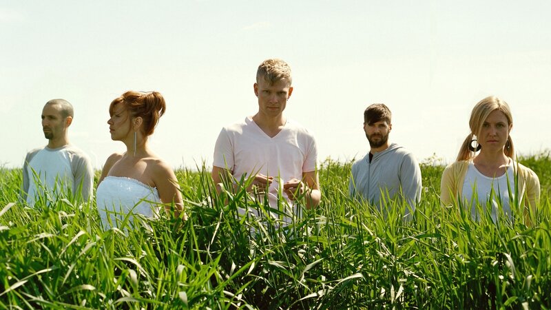 people in a field of tall grass