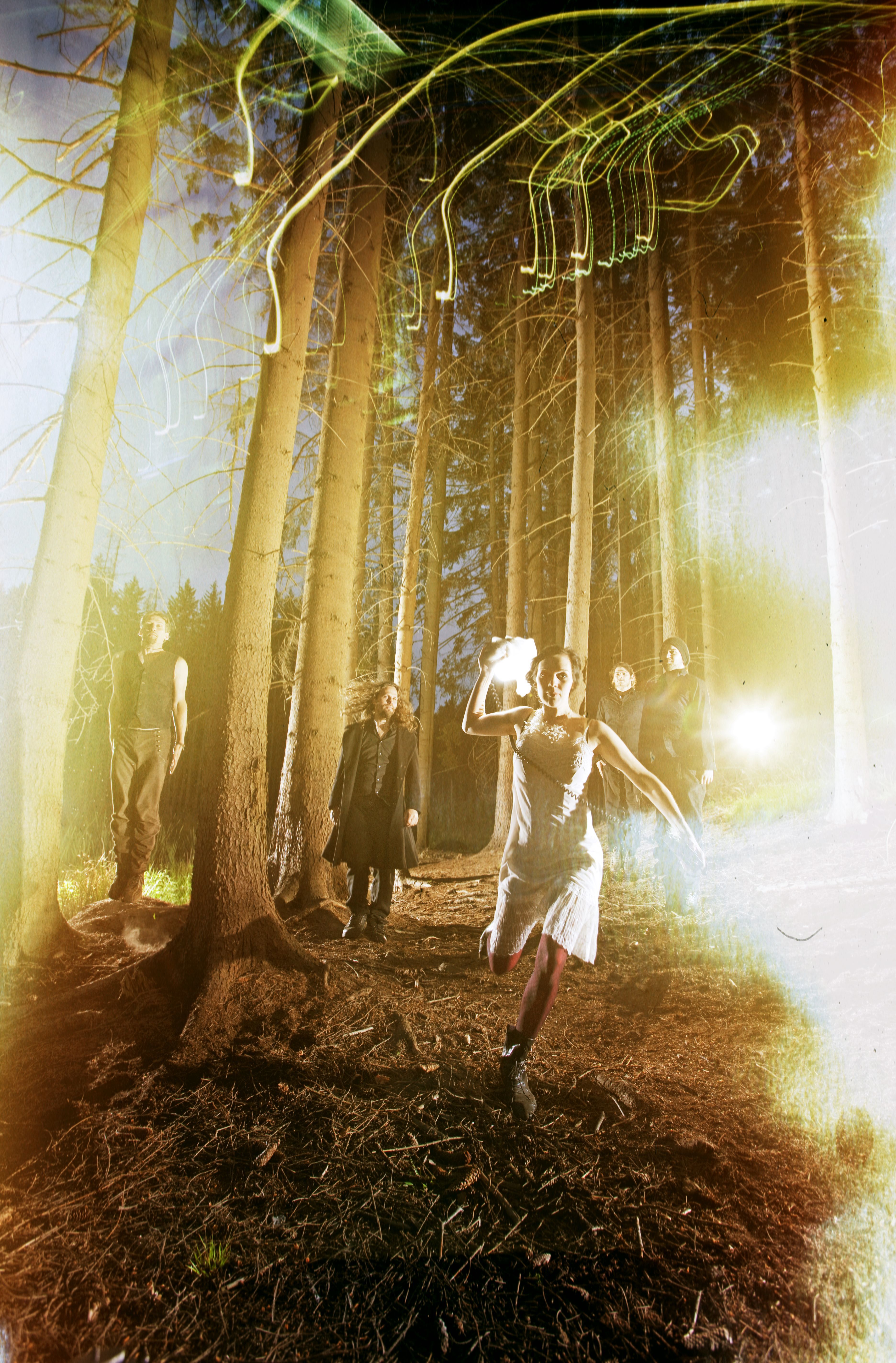 People in a forest with light effects