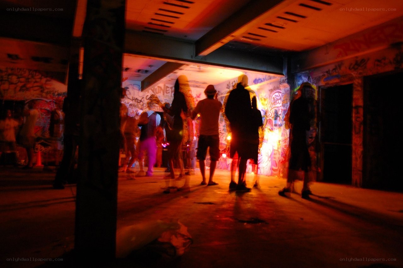 People in a graffiti-covered underpass