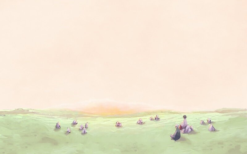 People in a green field at sunset