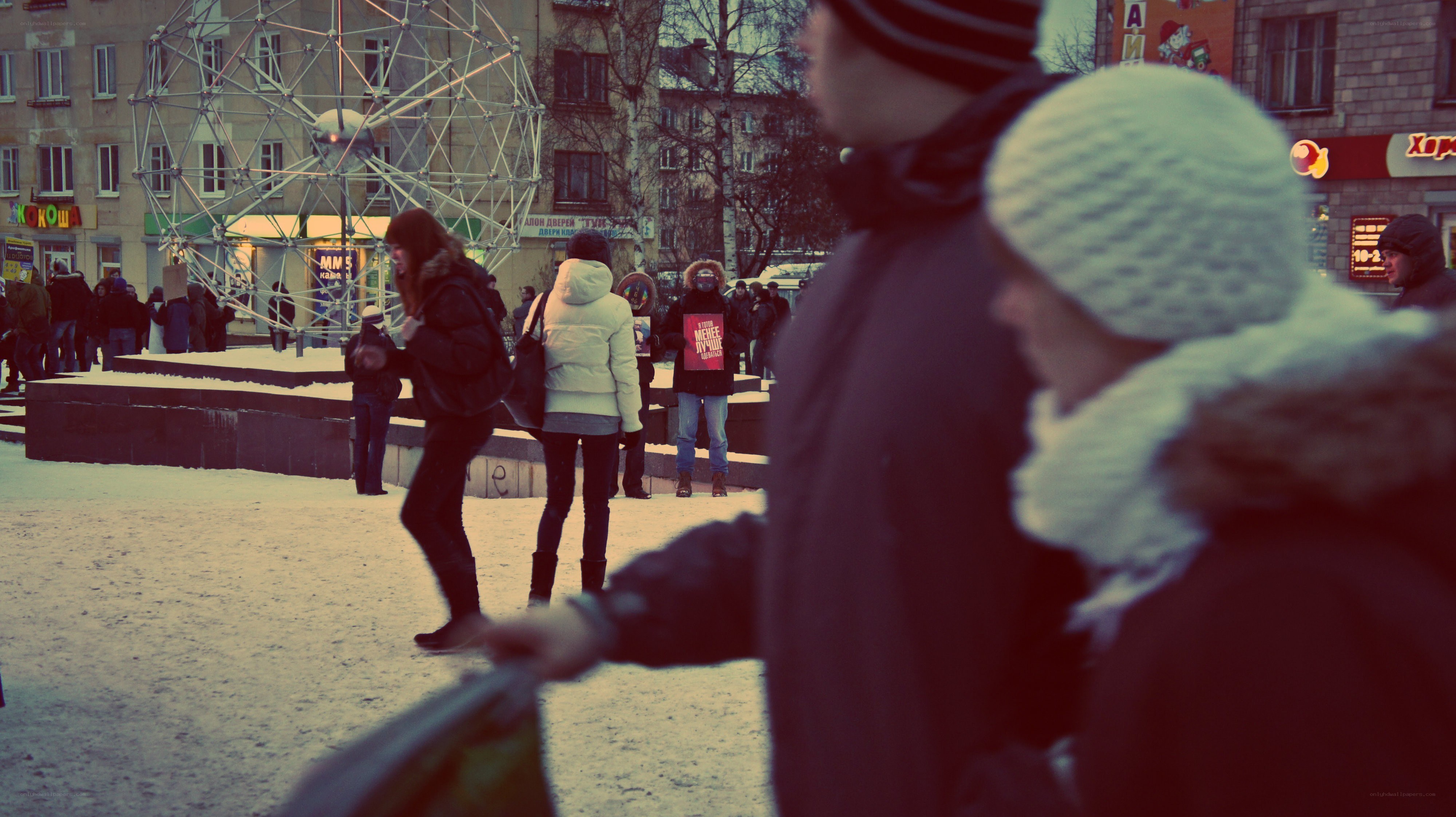 People in a snowy city square