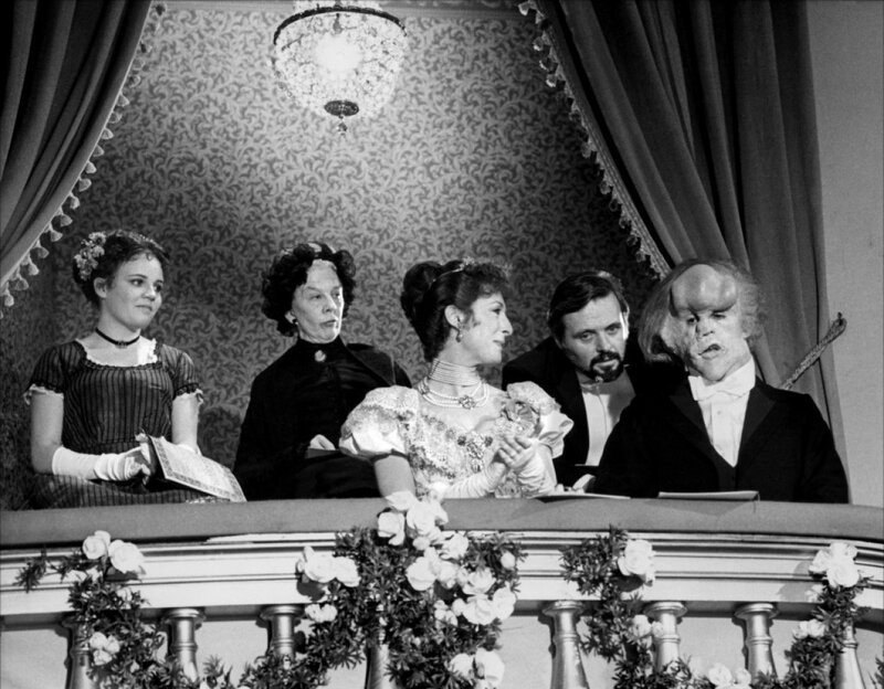 People in a Theater Box