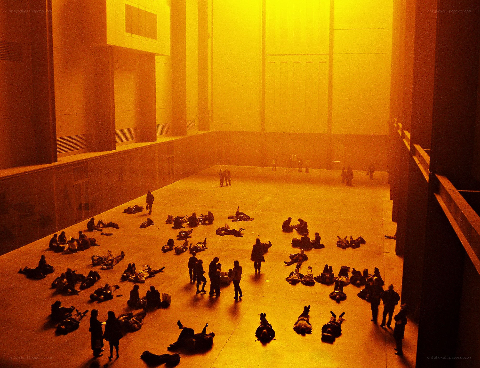 People in a yellow-lit hall