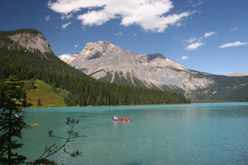 People in Canoes on Lake