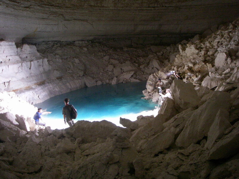 People in Cave with Pool
