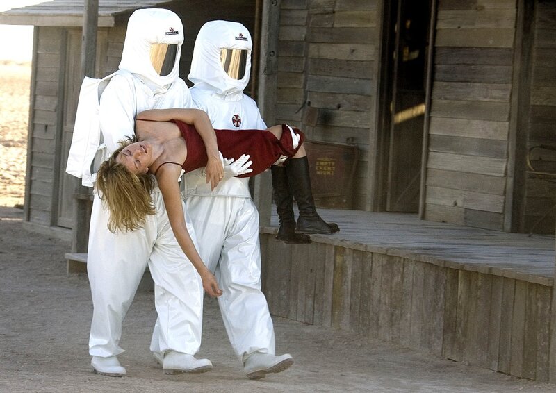 people in hazmat suits carrying woman
